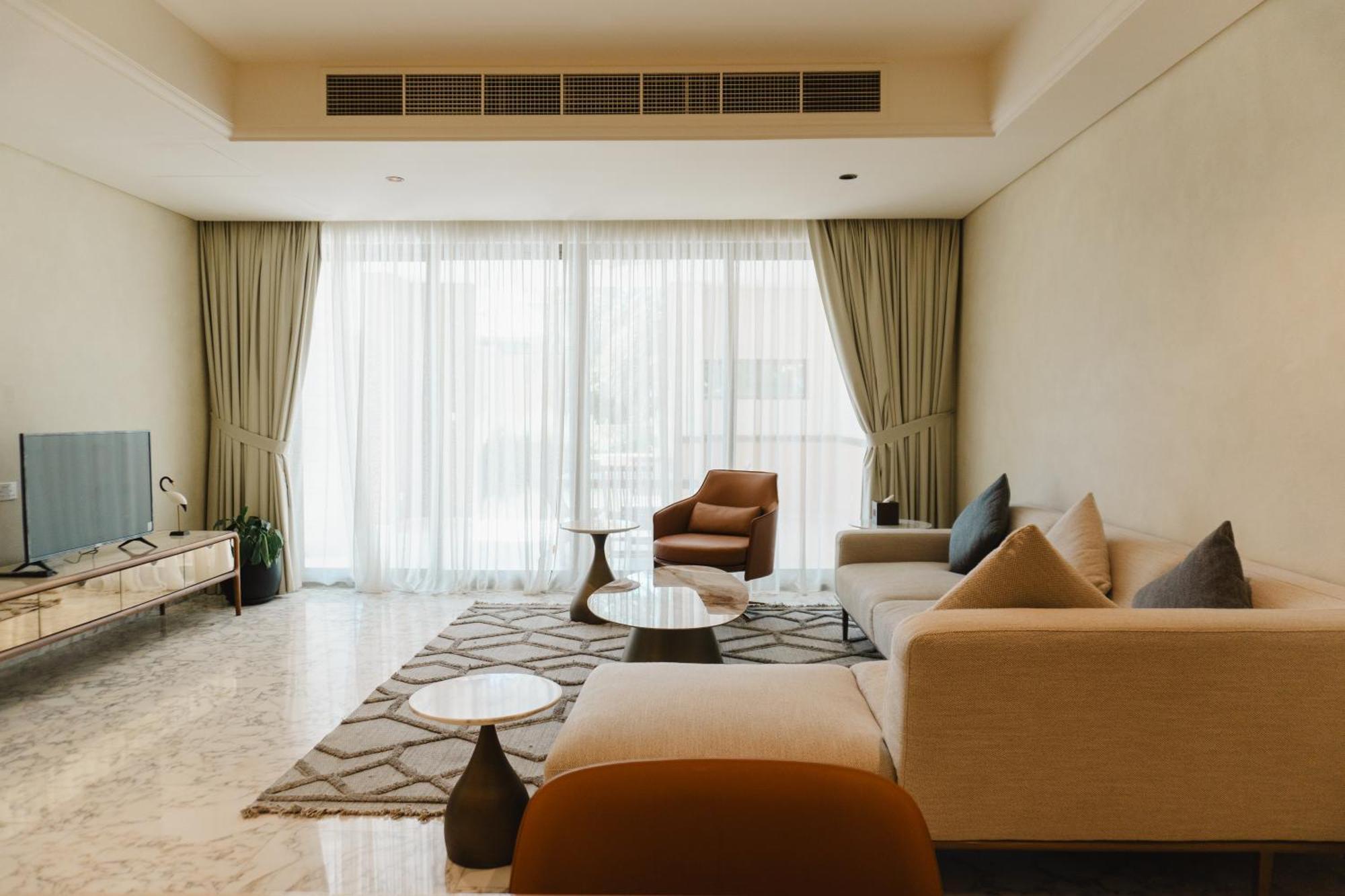 Palavra Resort Manama Exterior photo A living room in a condominium